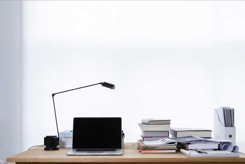 a desk with books and a computer