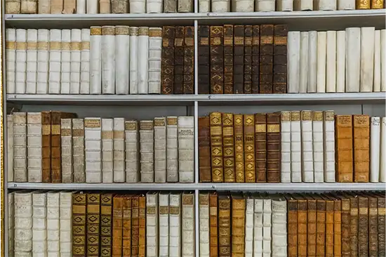 a bookshelf featuring old volumes